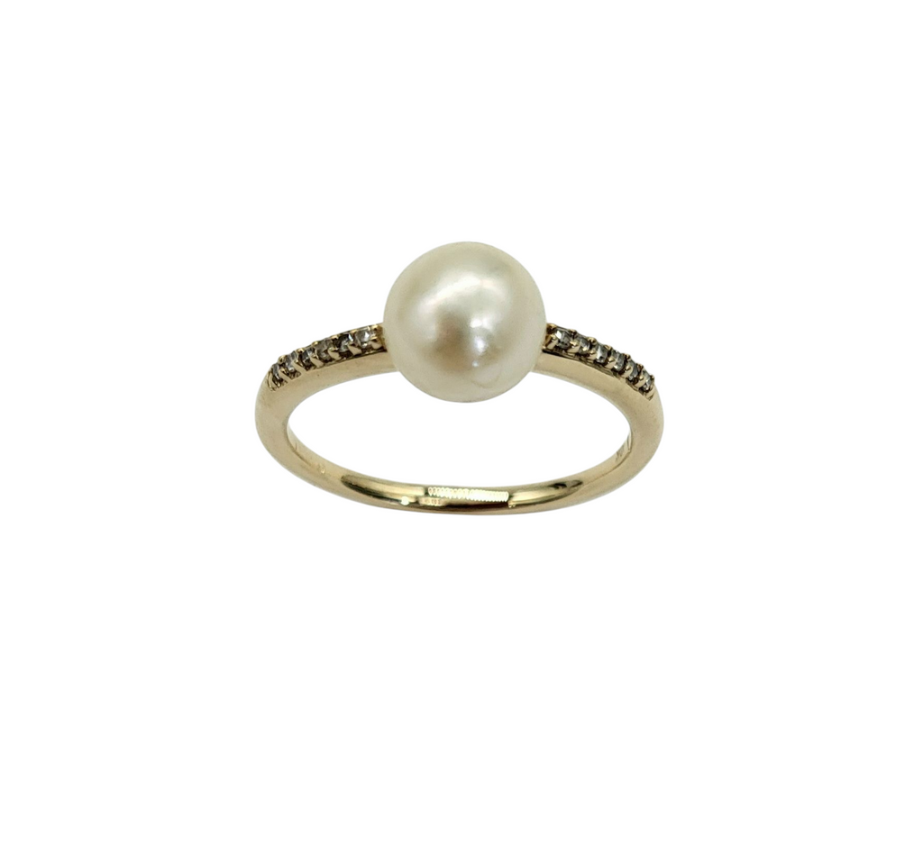 Gold ring with a pearl and small diamonds on a white background