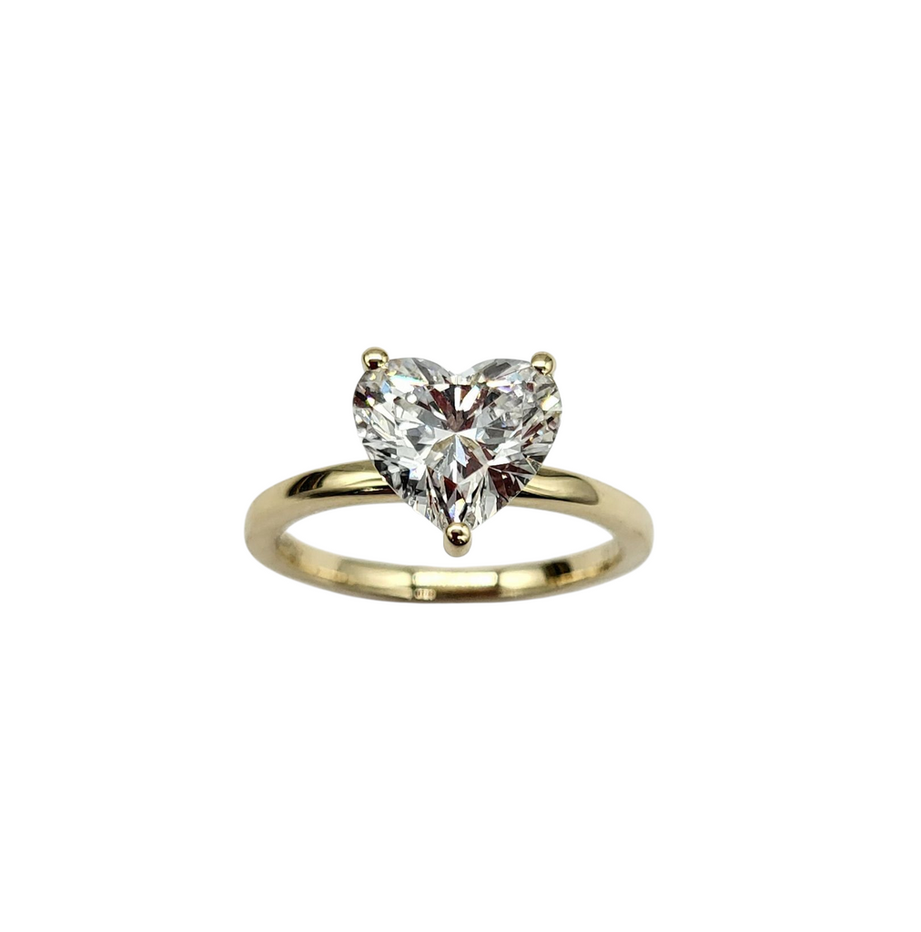 Heart-shaped diamond ring on a white background