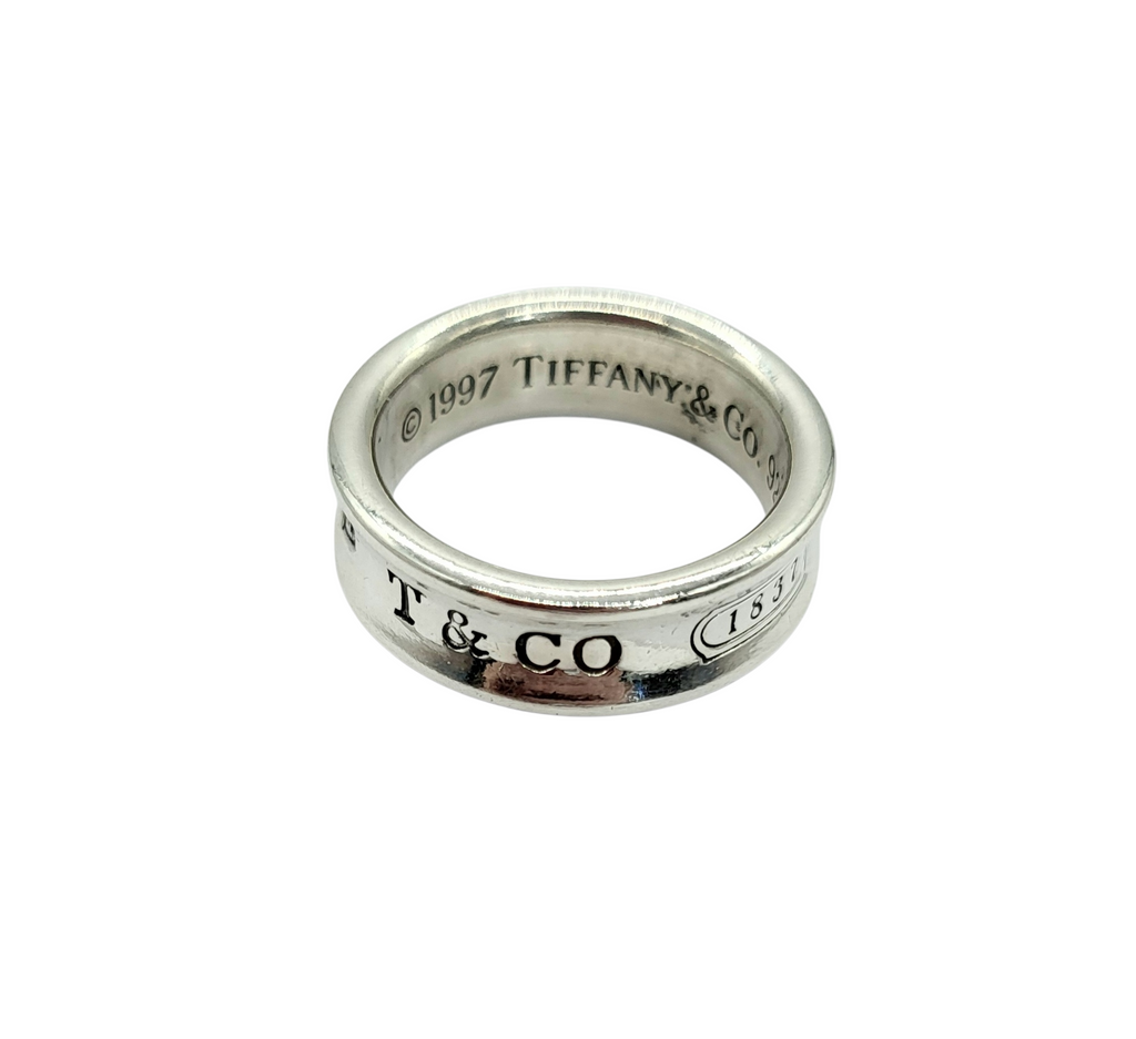 Silver Tiffany & Co ring on a white background