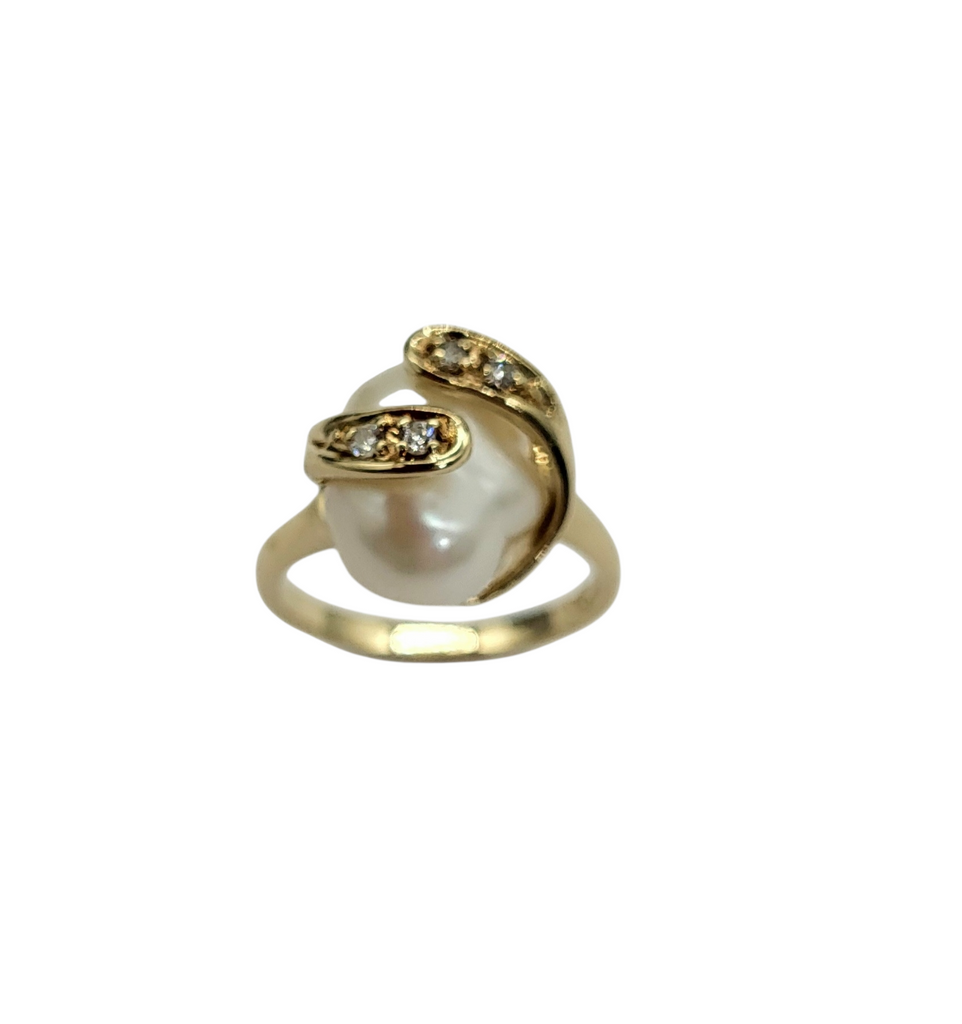 Gold ring with a pearl and small diamonds on a white background