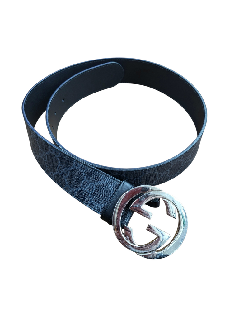 Blue belt with silver Gucci buckle on a white background