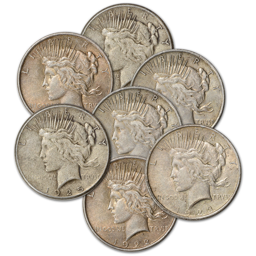 Collection of silver Peace Dollar coins on a white background