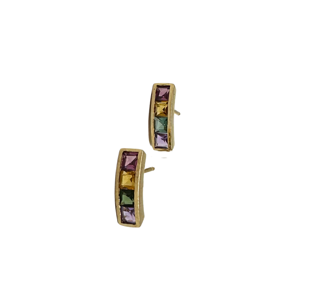 Gold hoop earrings with multicolored gemstones on a white background