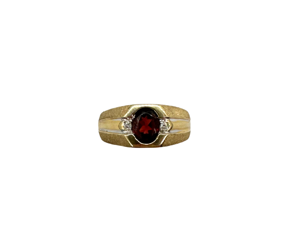 Gold ring with a red gemstone on a white background