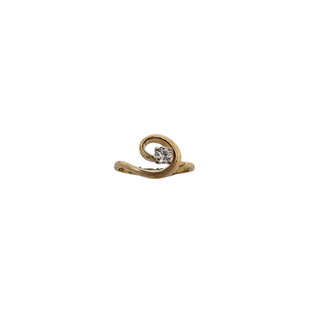 Gold ring with a diamond on a white background
