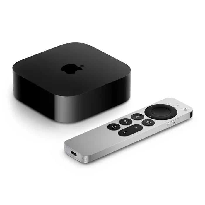 Black Apple TV box and silver remote control on a white background