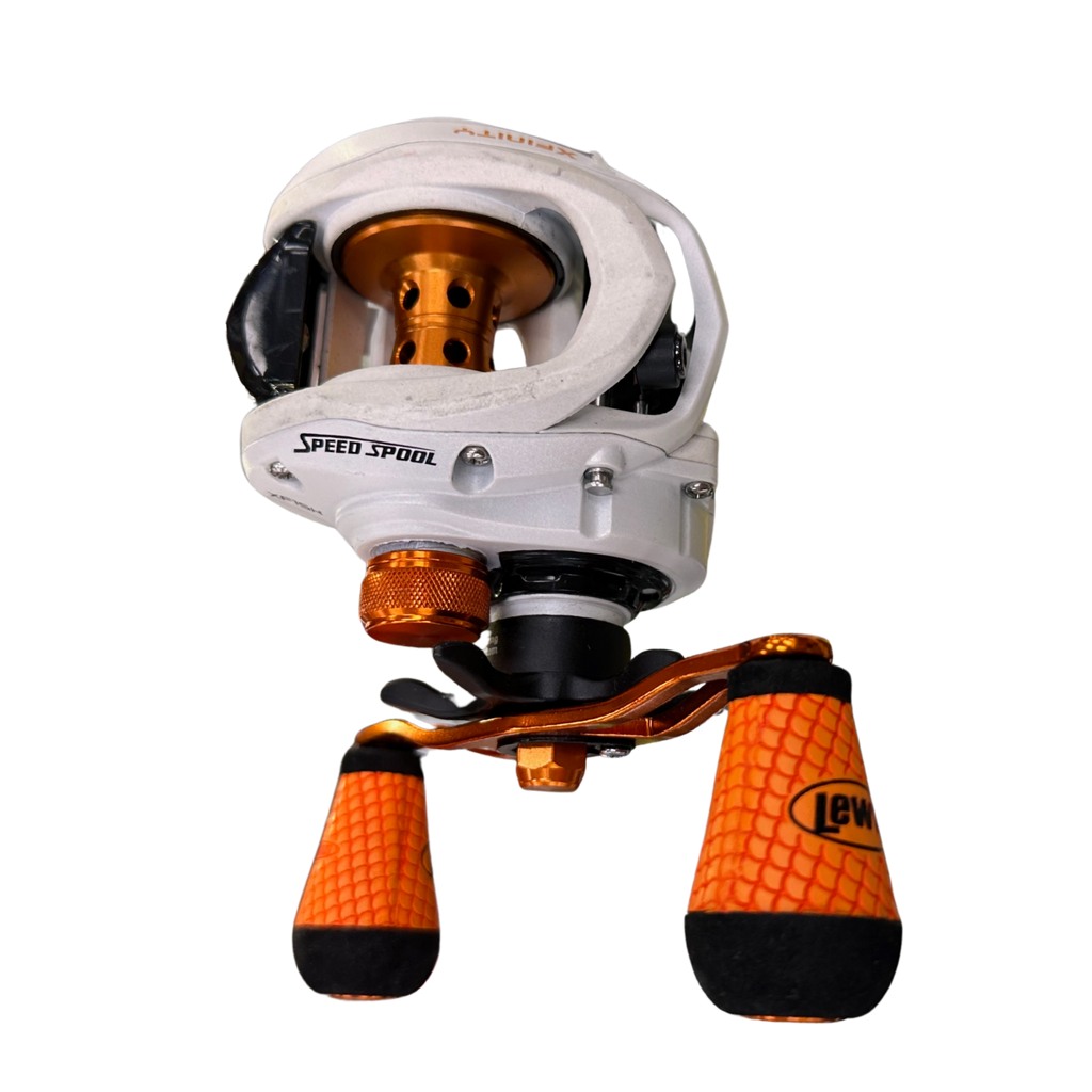 Fishing reel with orange and black accents on a white background