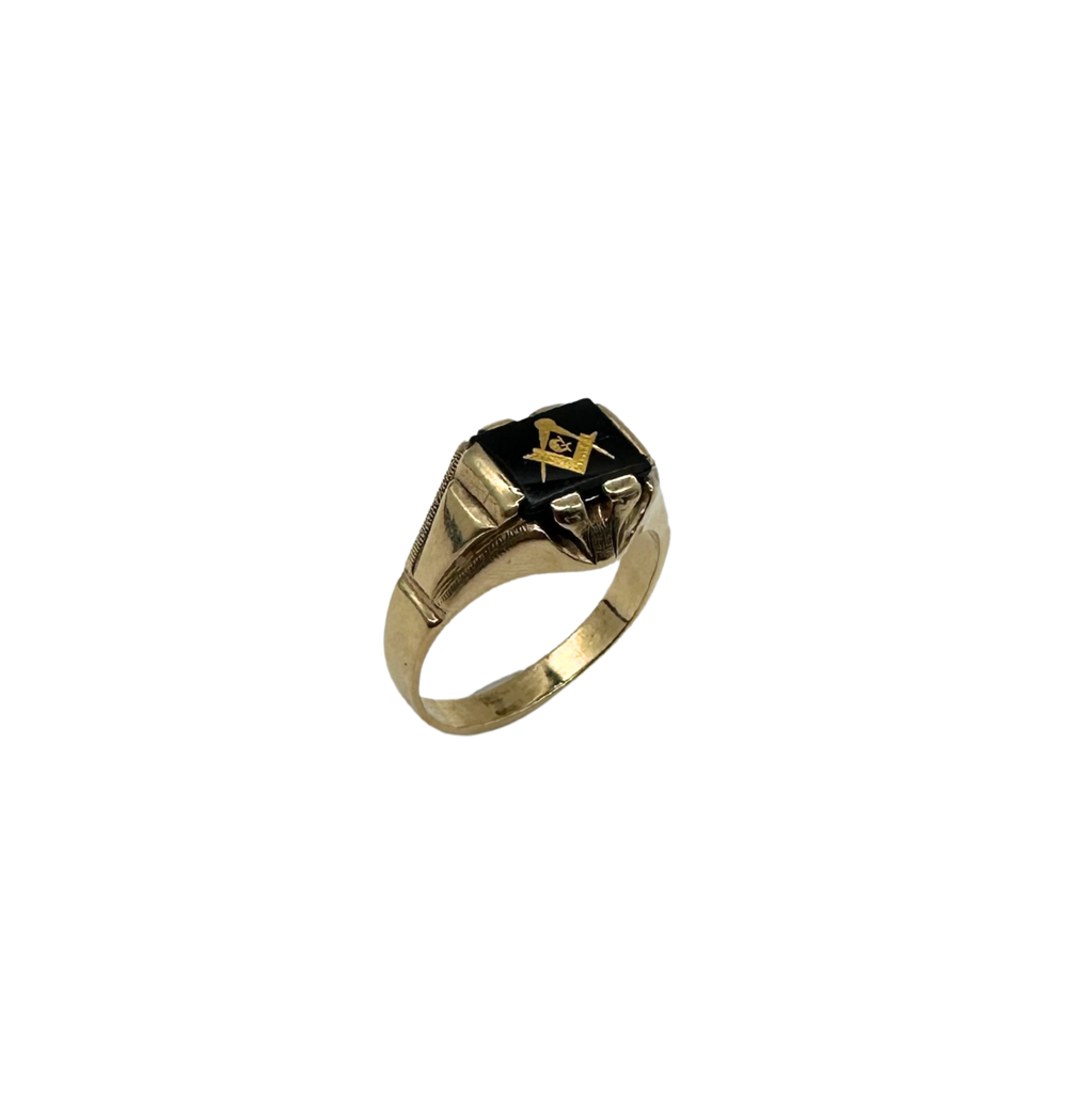 Gold ring with a black stone and Masonic symbol on a white background