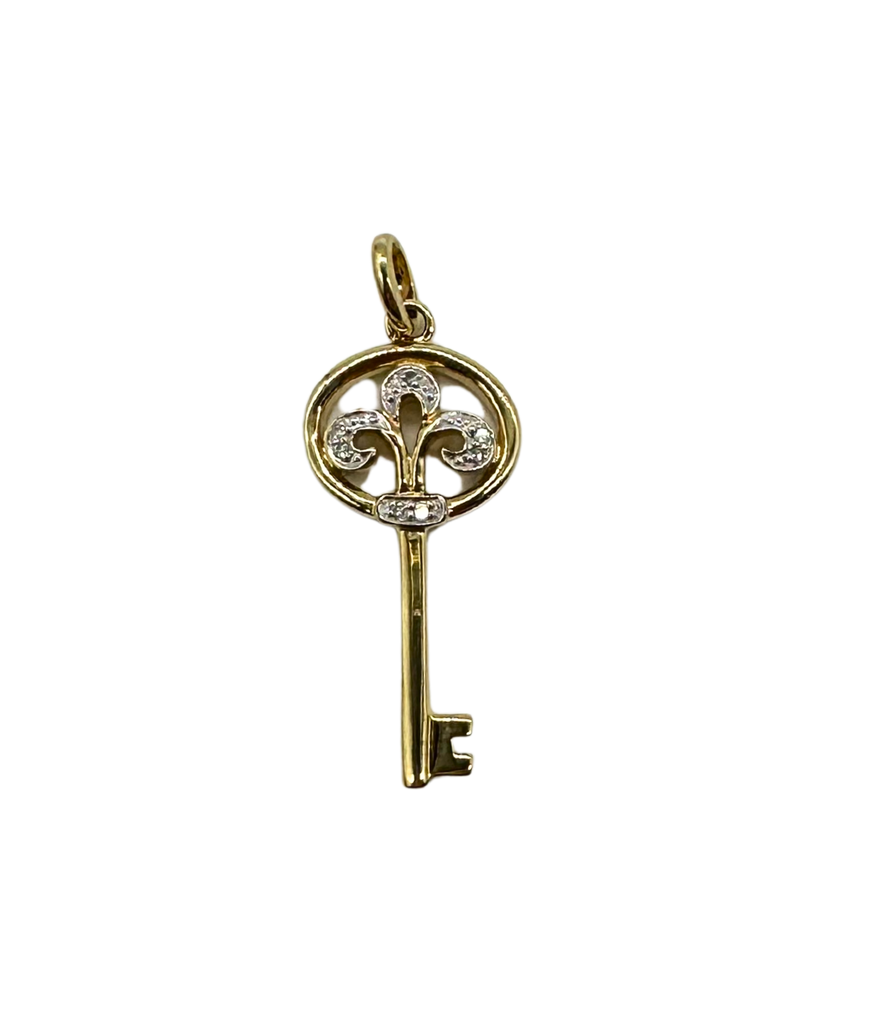 Gold key-shaped pendant with diamond accents on a white background