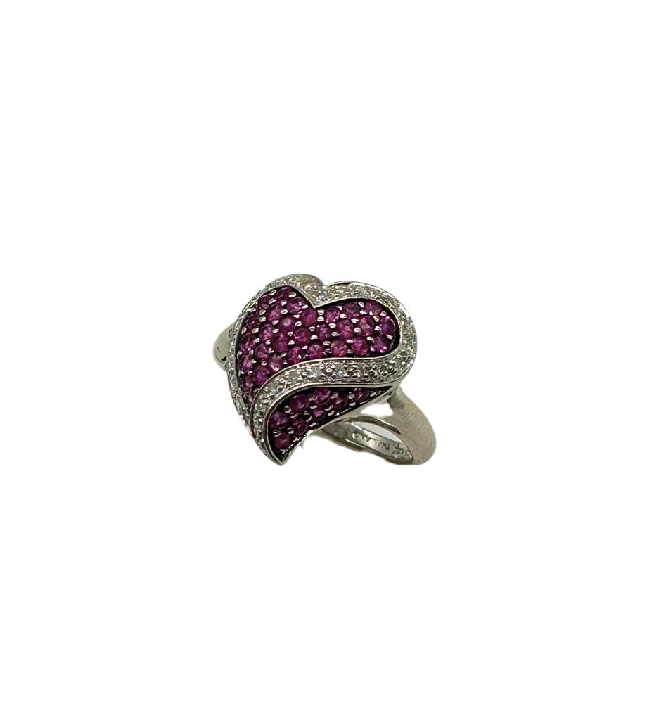 Heart-shaped ring with pink gemstones on a white background