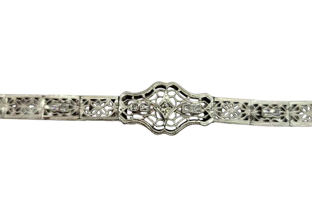 Silver bracelet with intricate design on a white background