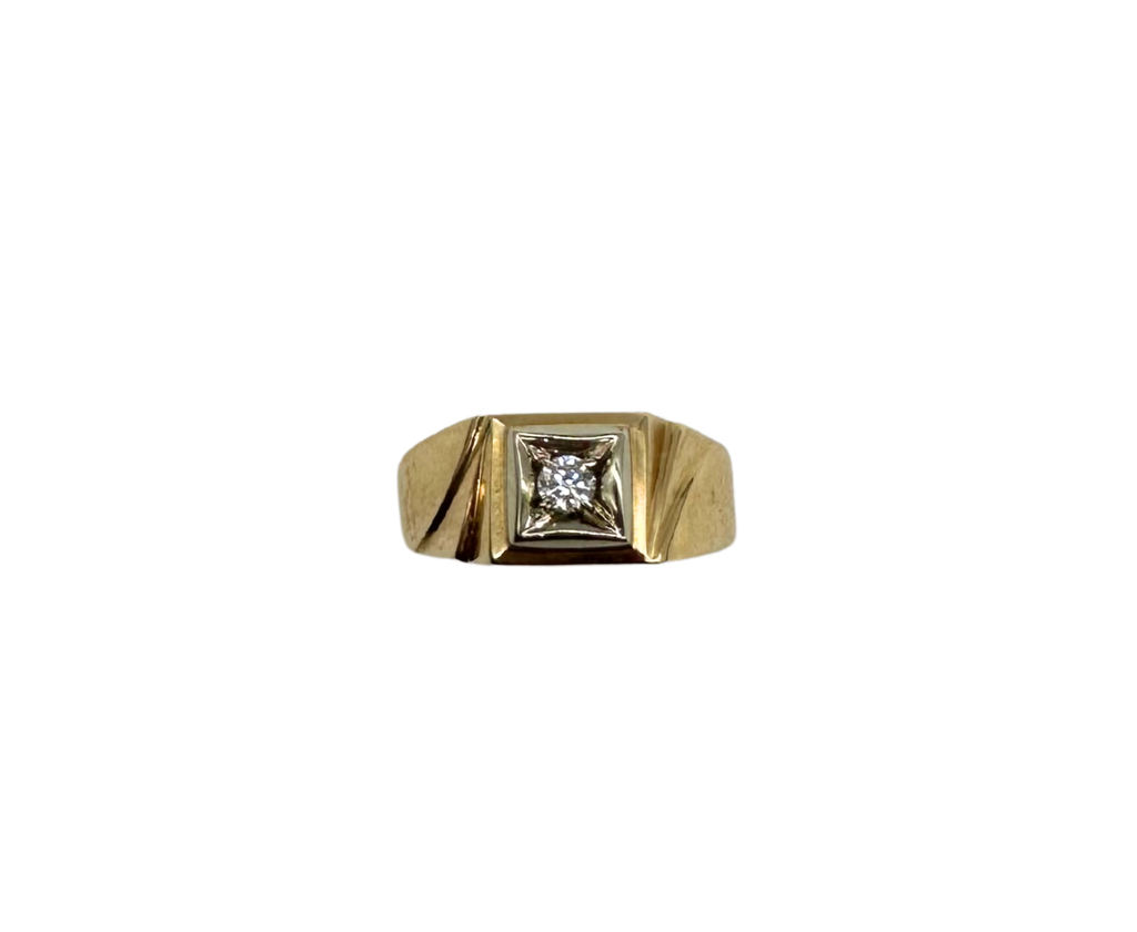 Gold ring with a diamond on a white background