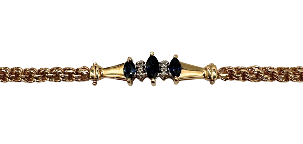 Gold bracelet with black gemstones on a white background
