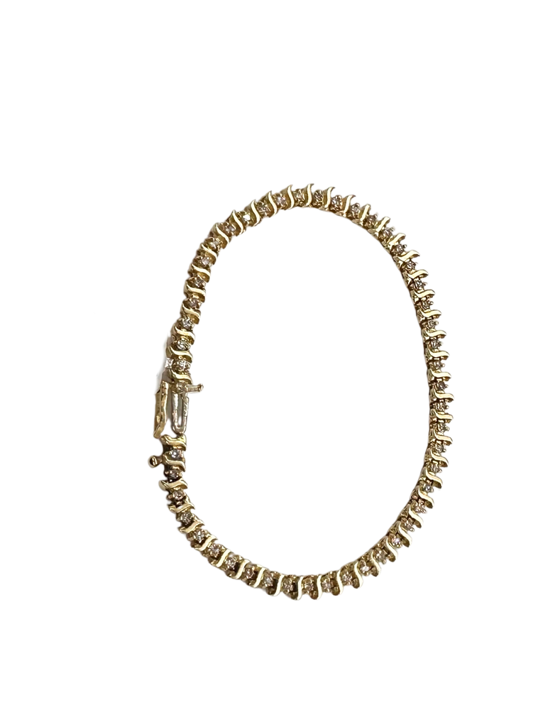 Gold bracelet with clear stones on a white background
