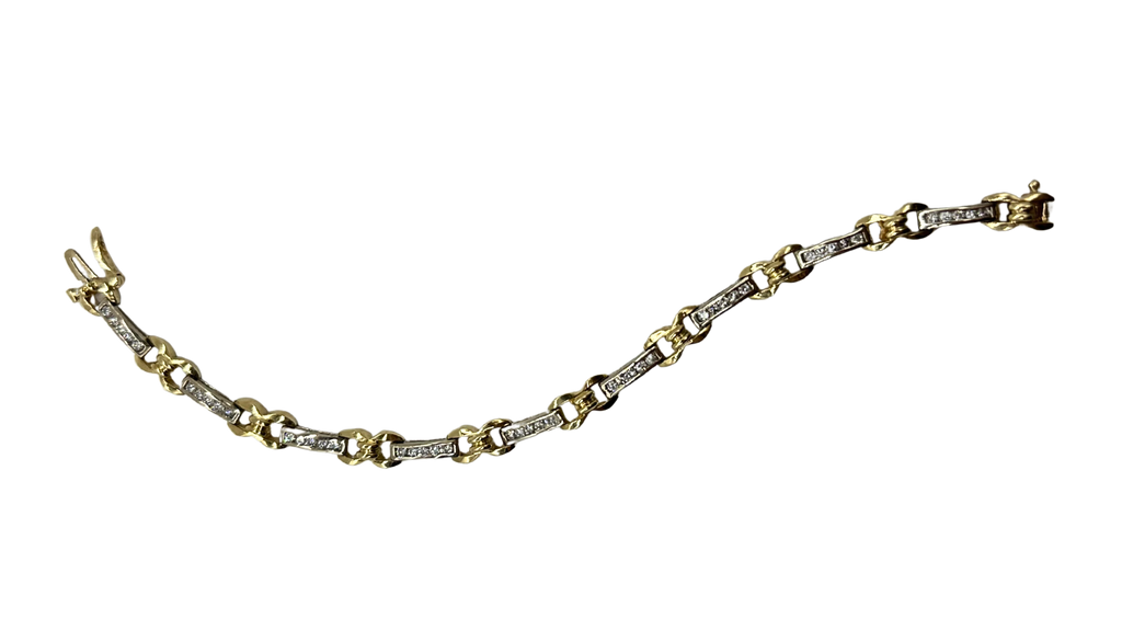 Gold and silver bracelet on a white background