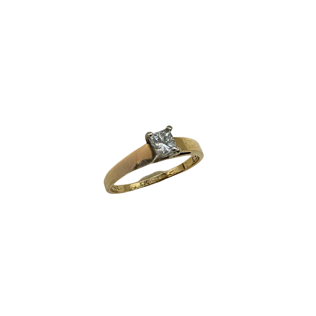Gold ring with a diamond on a white background
