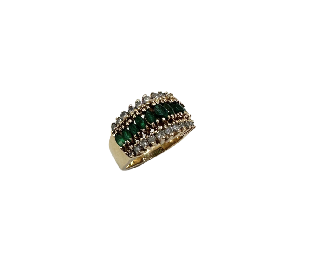 Gold ring with green gemstones on a white background