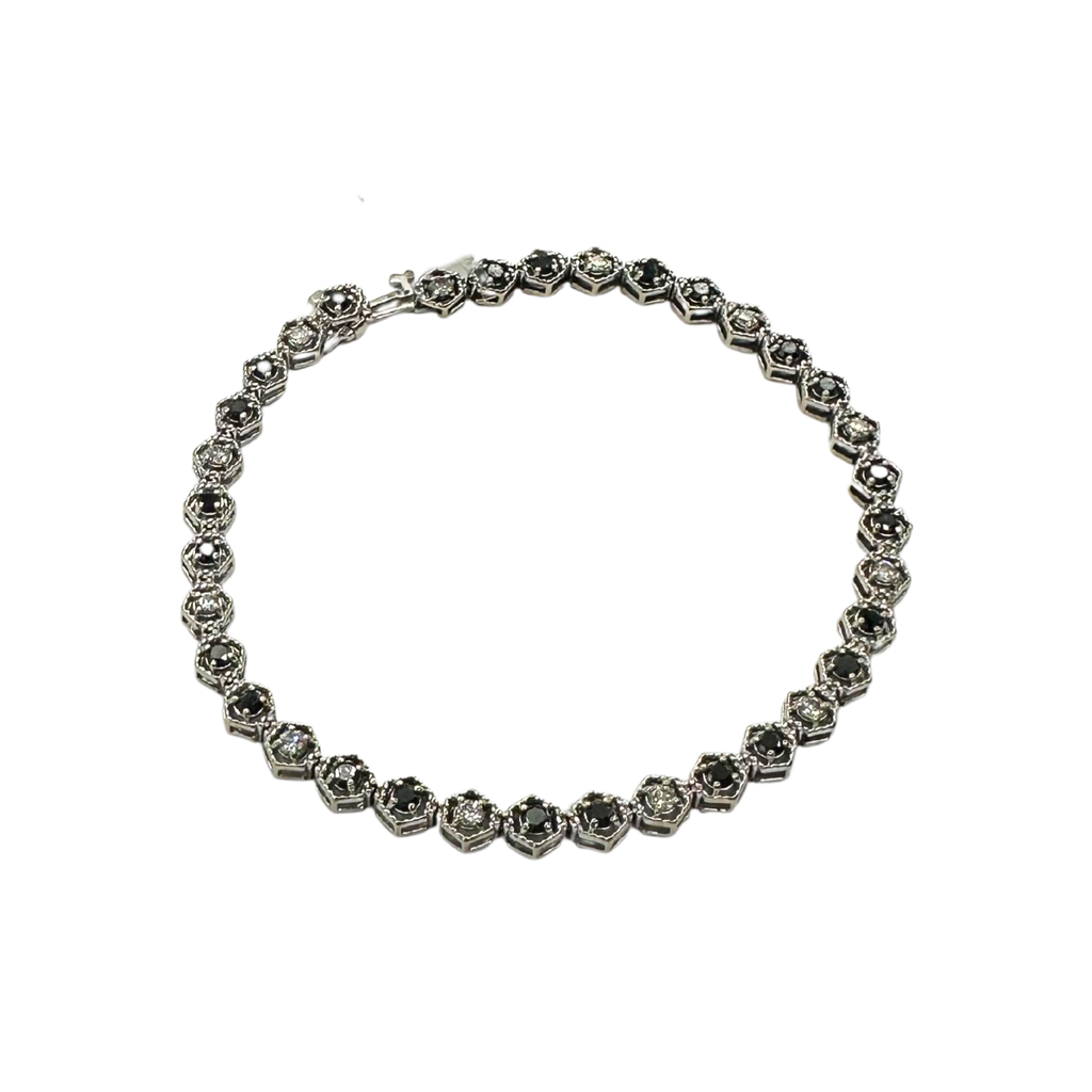 Silver bracelet with floral designs on a white background