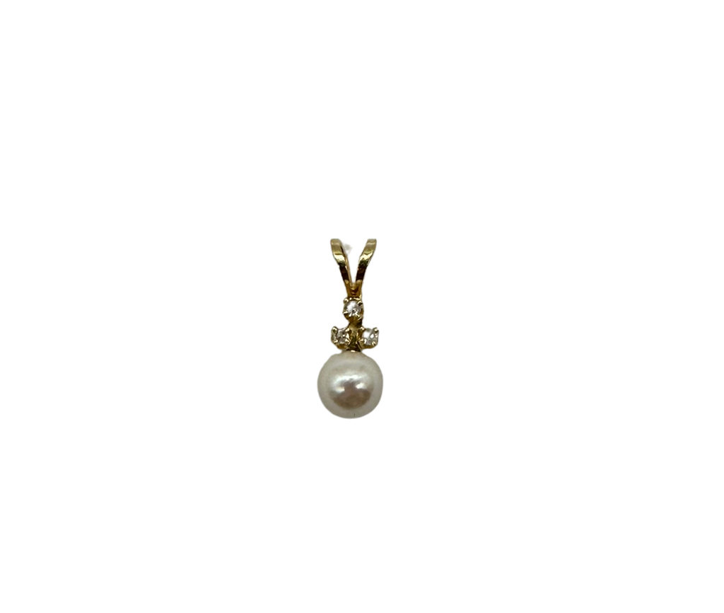 Gold pendant with a pearl and small gemstone on a white background