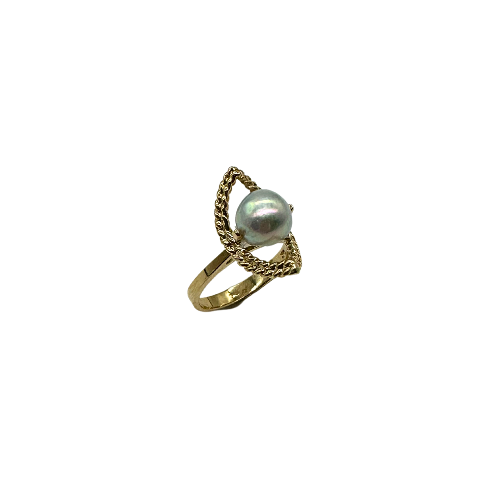 Gold ring with a pearl on a white background