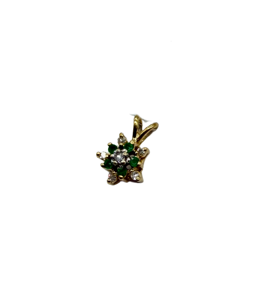 Gold pendant with green gemstones and clear stones on a white background