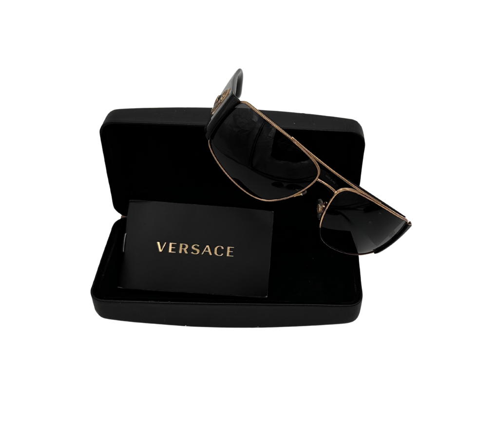 Versace sunglasses in a black box on a white background