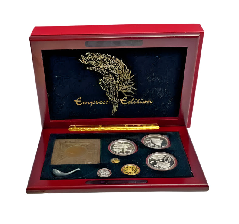 Emperor Edition commemorative gold and silver proof set in a red box with certificates of authenticity on a white background.