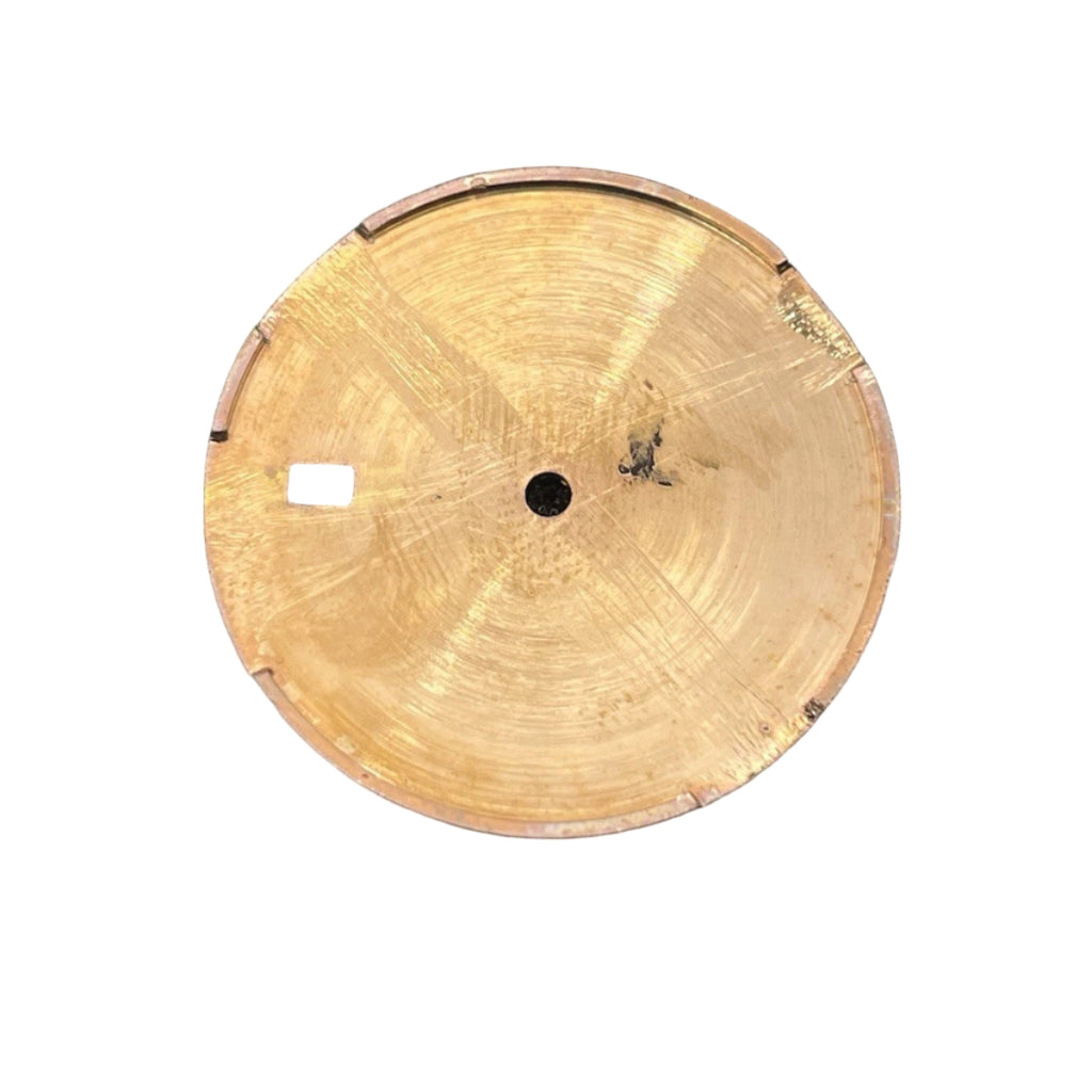 Gold circular object on a black foam background