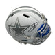 Silver football helmet with star logo and 'COWBOYS' text on a gray background