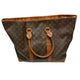 Brown monogram handbag with leather handles on a white surface