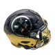 Black and gold football helmet with 'Steelers' logo on a white surface.