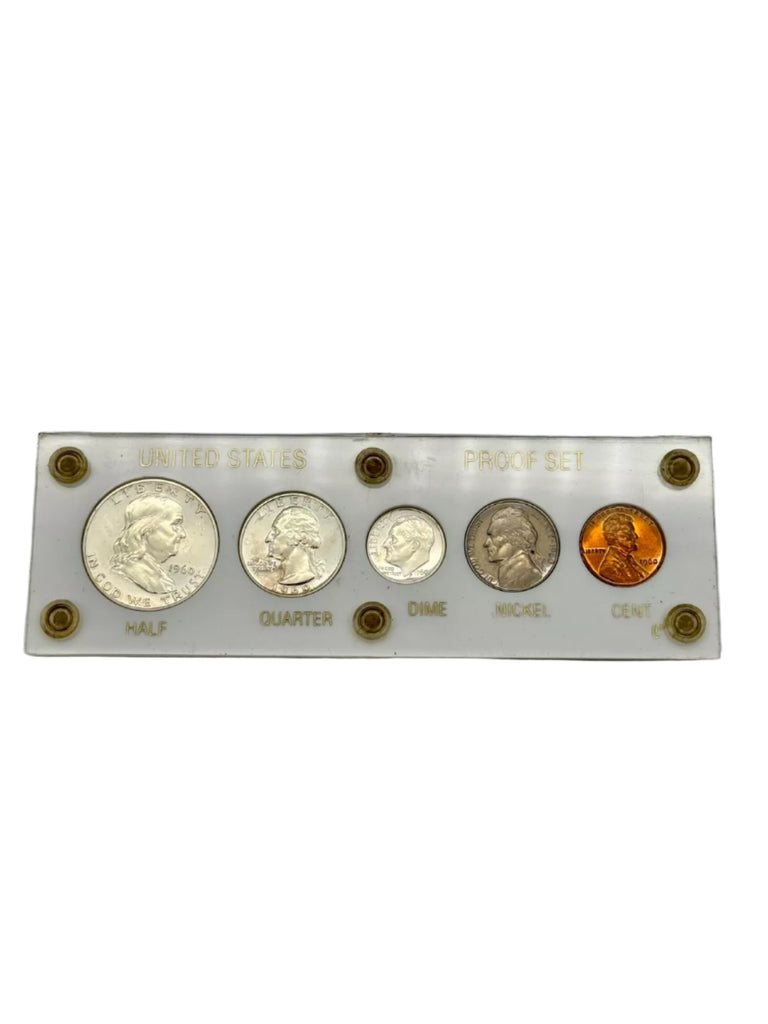 Set of U.S. coins on a display card with labels on a gray background