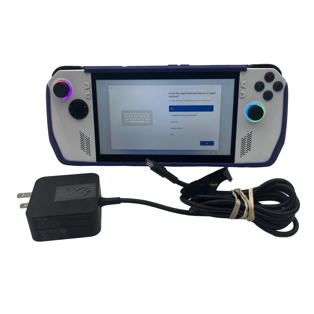 Handheld gaming console with screen displaying a menu, connected to a power adapter on a white background.