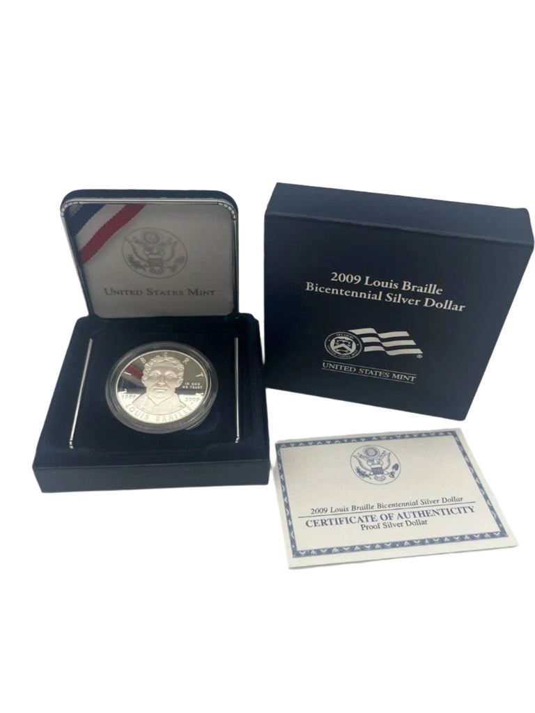 Silver dollar coin in display case with certificate of authenticity on a white background