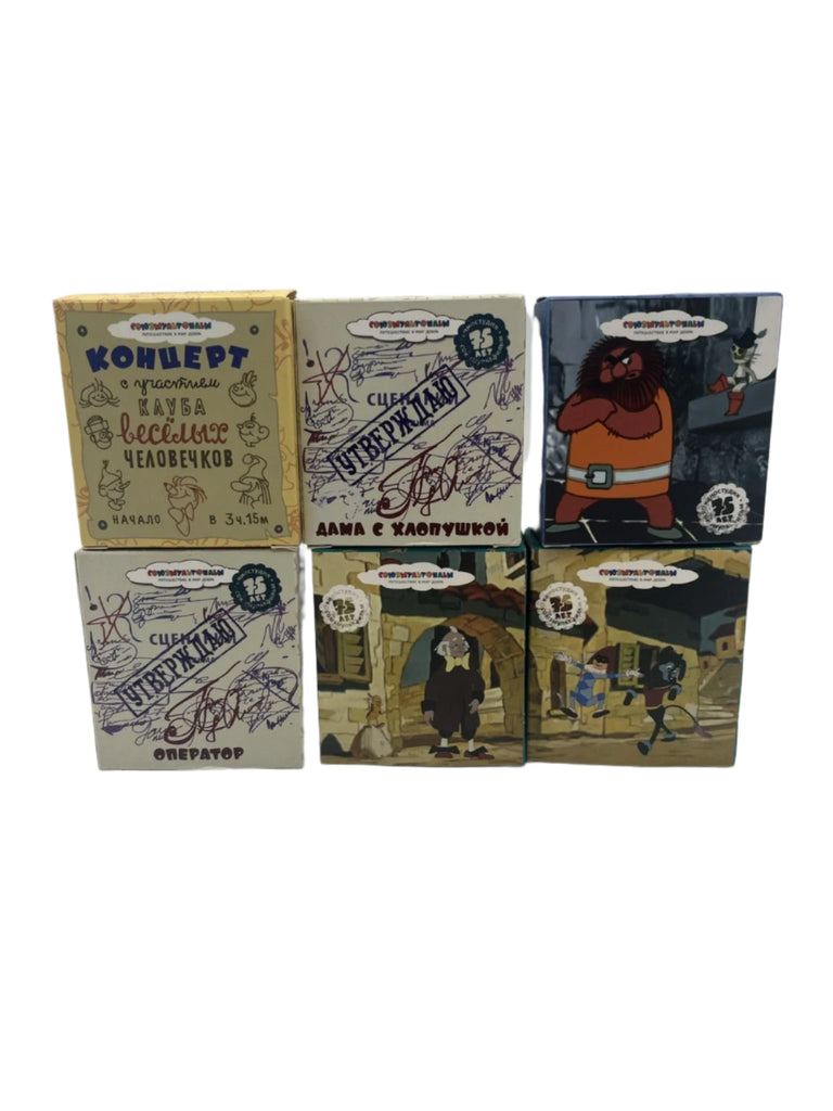 Set of six small boxes with various designs and text on a white background