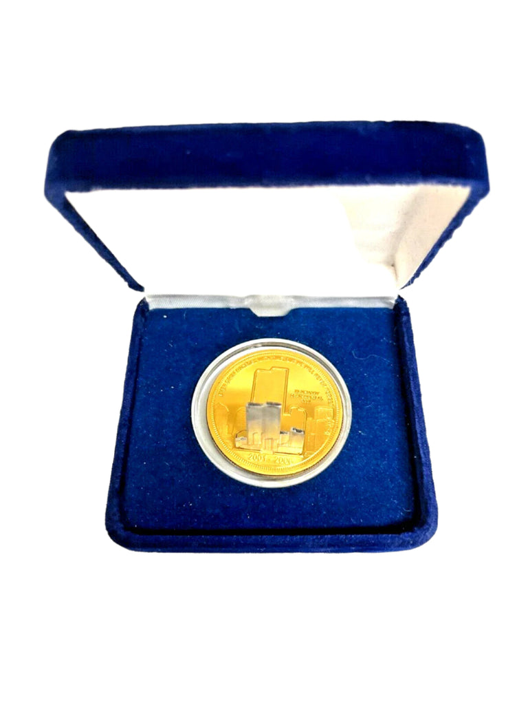 Gold coin in a blue velvet box on a white background