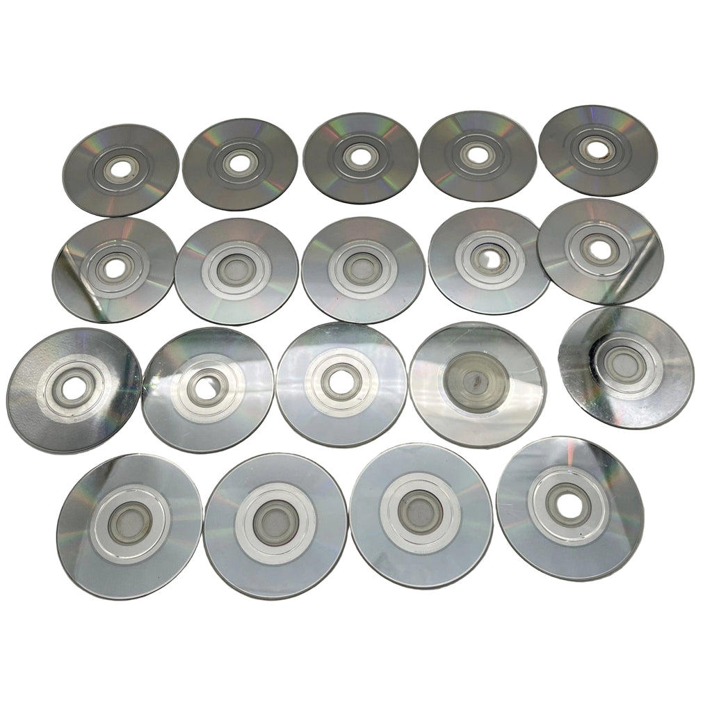 Twenty silver compact discs on a gray surface