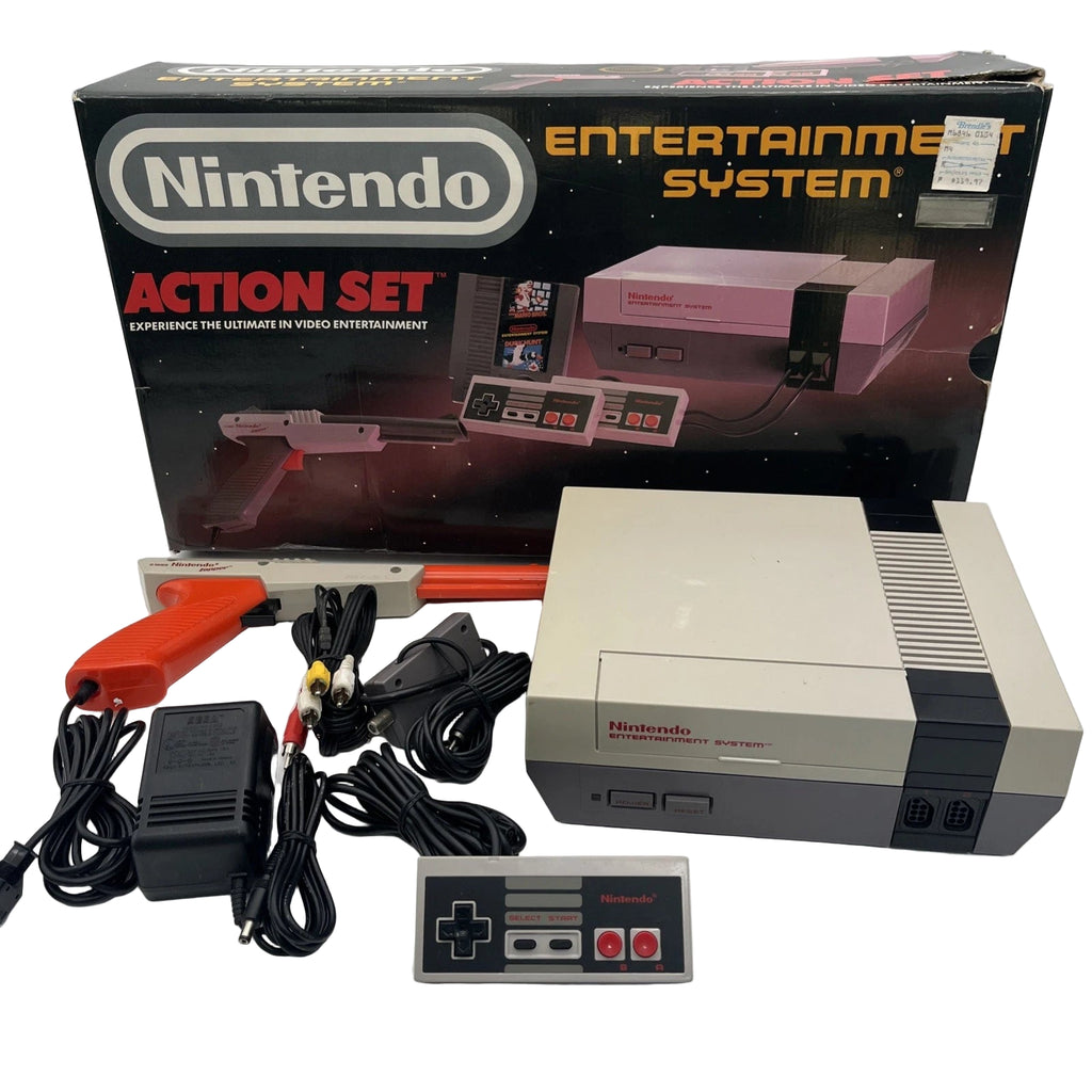 Nintendo Entertainment System Action Set with console, controller, and accessories on a white surface.